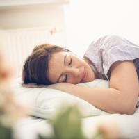 Woman sleeping alone in her bed bug free bed.